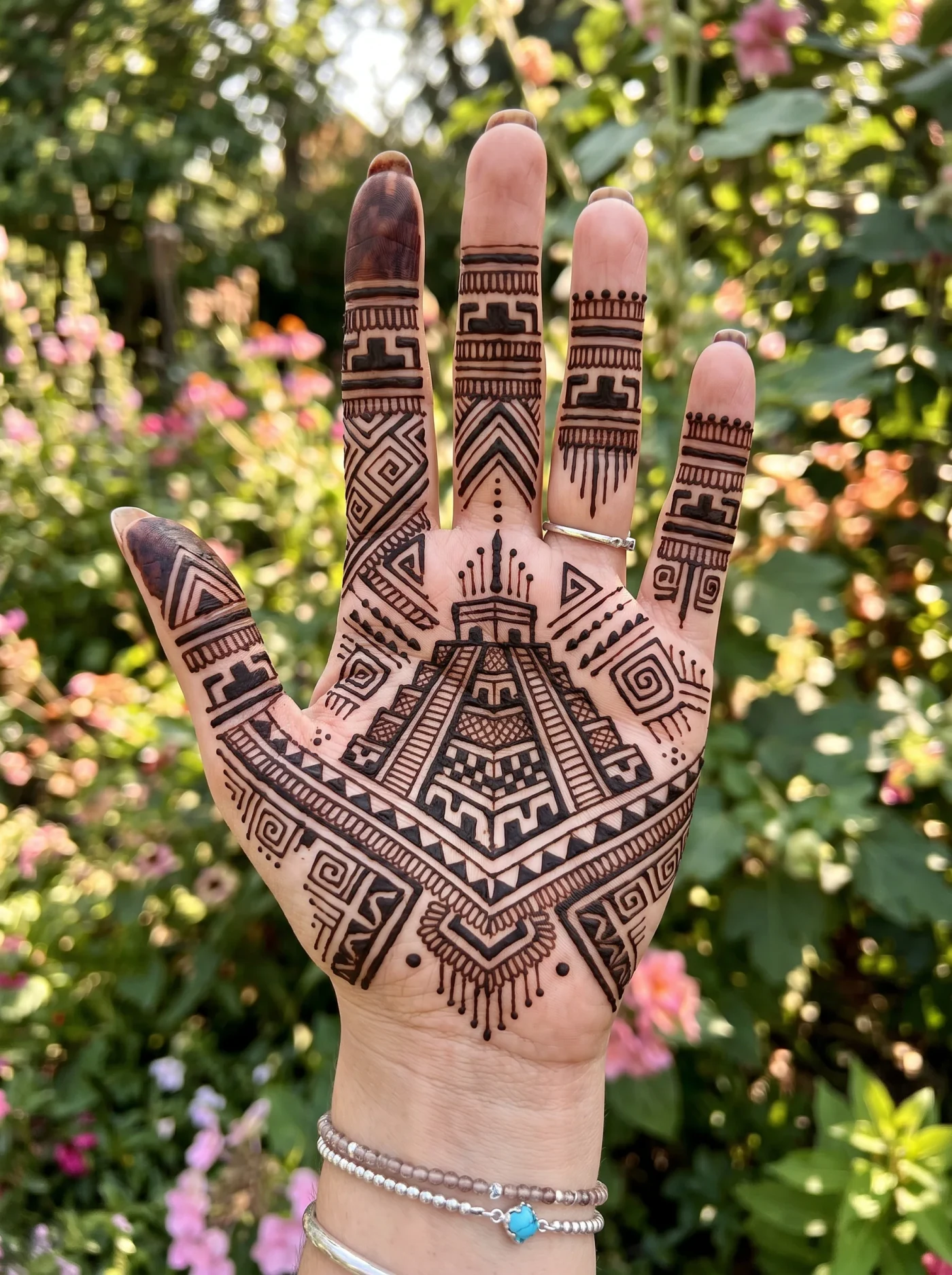 Aztec inspired geometric mehndi pattern on the palm